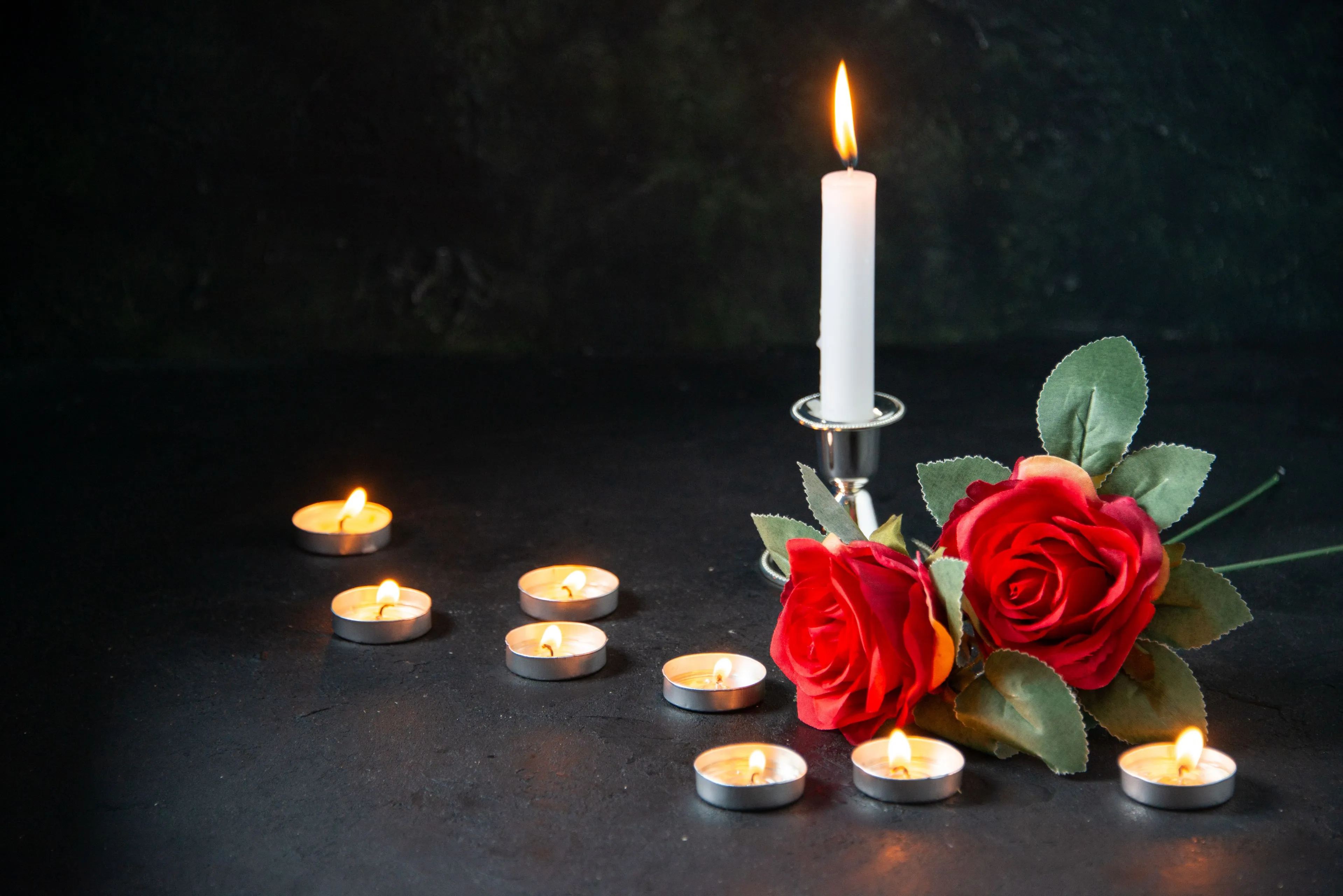 front view burning candles as memory fallen dark surface