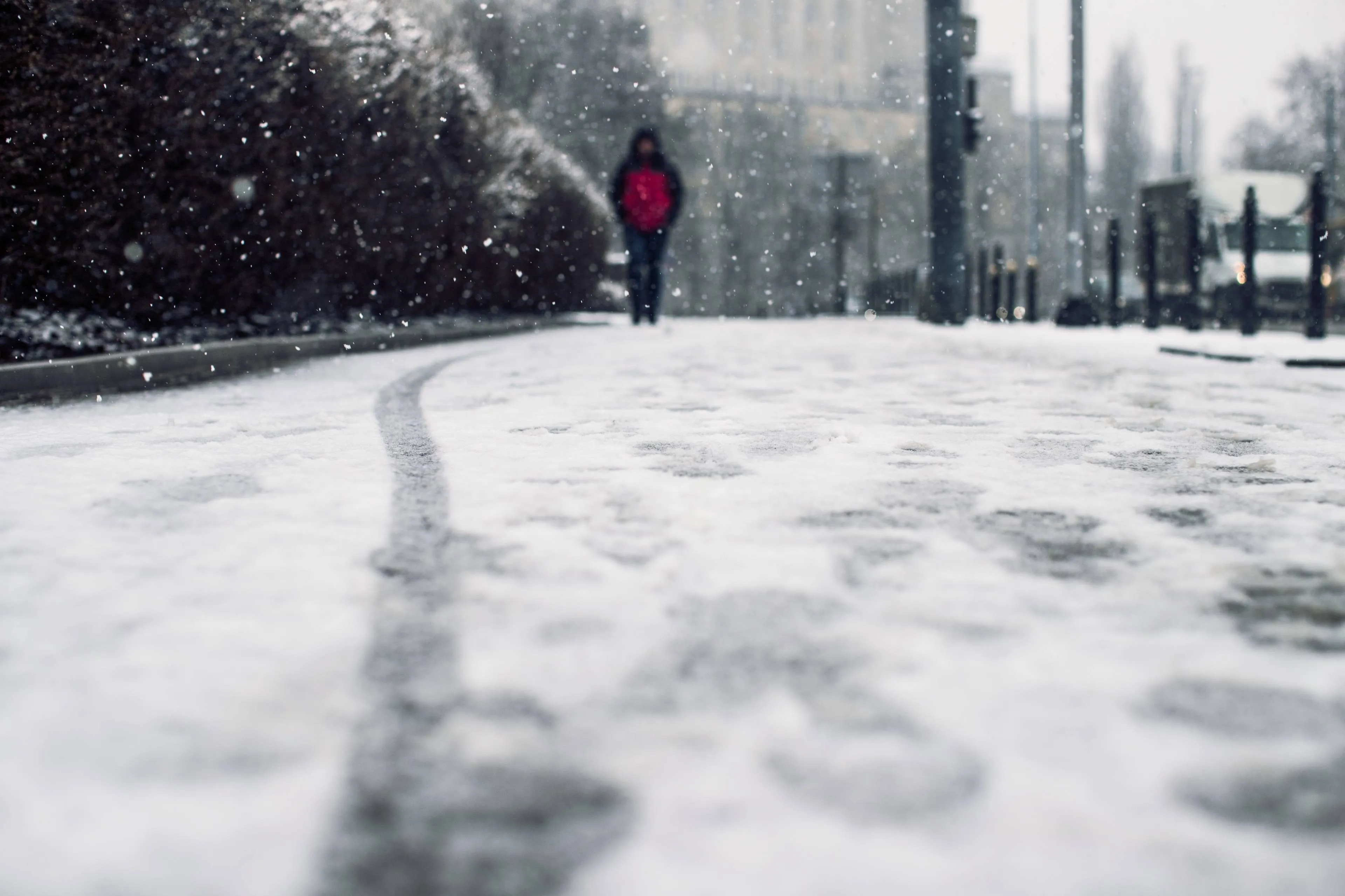 low angle shot person walking snow covered sidewalk snow
