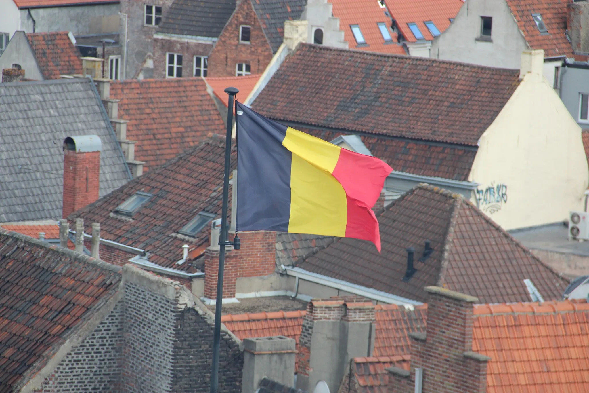 belgian flag flying over city in belgium