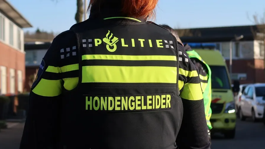 politie hondengeleider stock