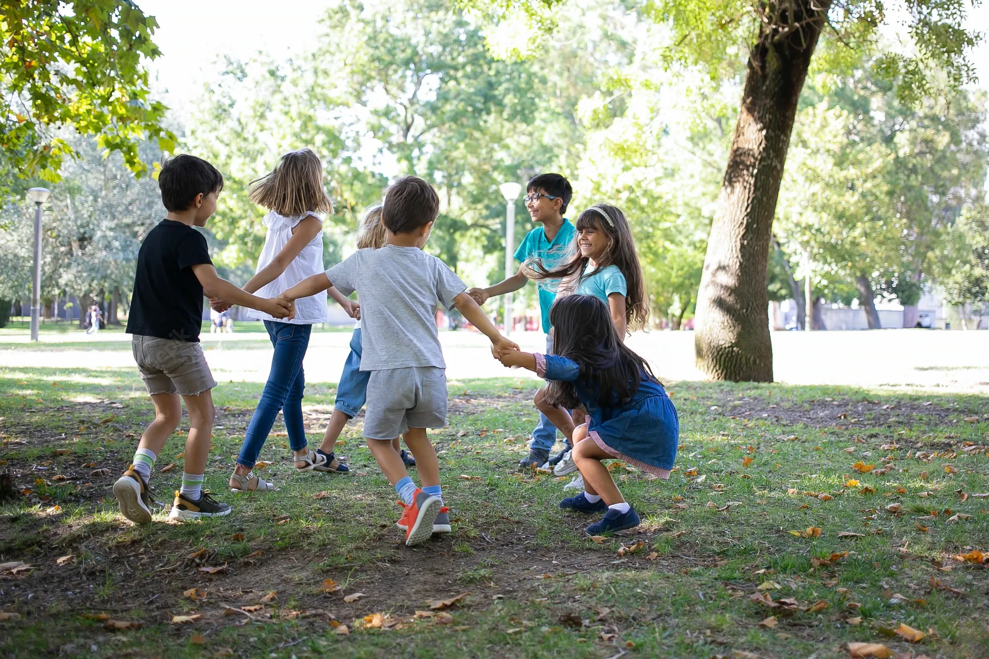 happy children playing together outdoors dancing around grass enjoying outdoor activities having fun park kids party friendship concept 74855 11760