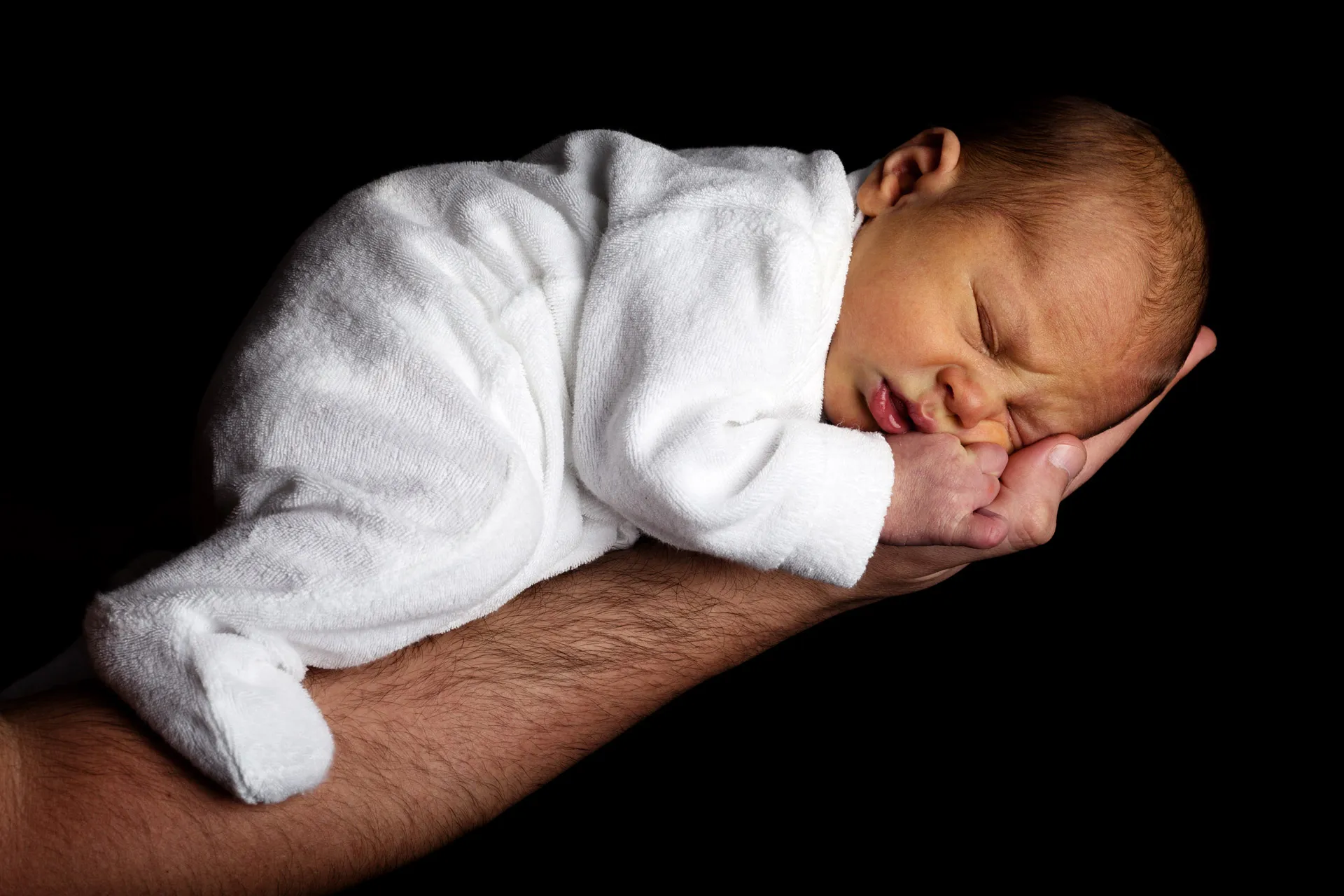 newborn baby on an arm