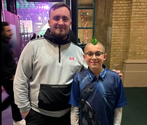 10-year-old Lennon Wharf proudly poses with Luke Littler