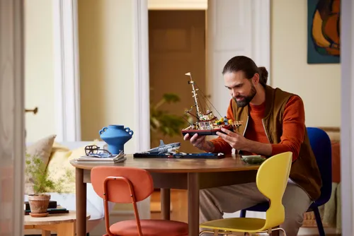 man building lego interior 21350 lifestyle