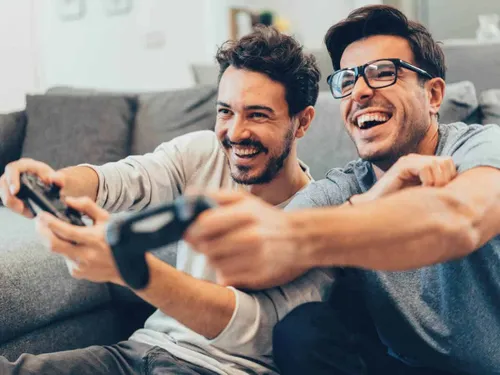 two guys happy playing video games