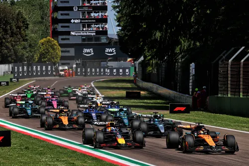 Max Verstappen and Oscar Piastri entering turn 1 during the Emilia-Romagna Grand Prix.