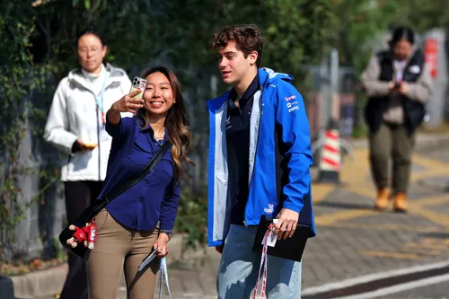 Colapinto poses in the paddock with a fan