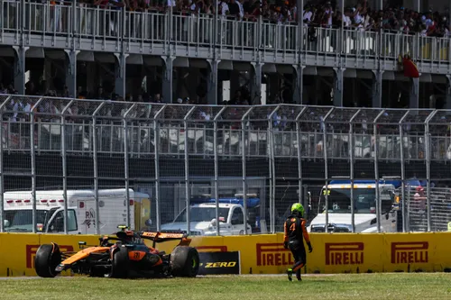 Lando Norris walks away from his stricken McLaren