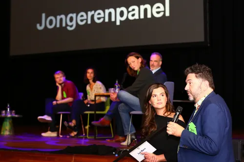 fleur huijs in gesprek met jur botter wethouder jeugdzaken met op de achtergrond het jongerenpanel