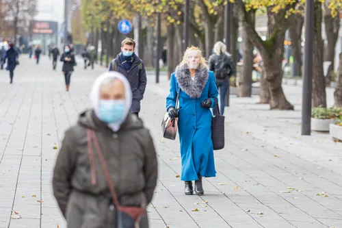 Žmonės su apsauginėm kaukėm