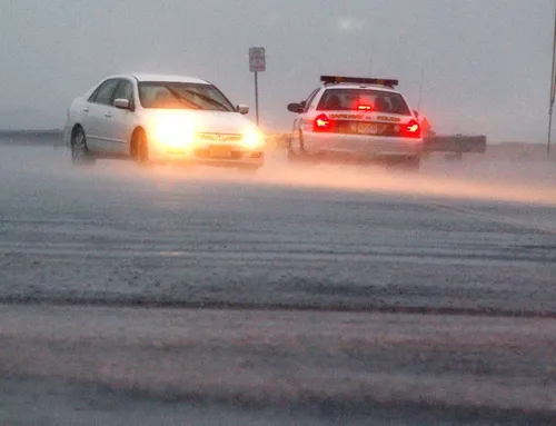 a cape may nj police office talks with a motorist in a driving rain