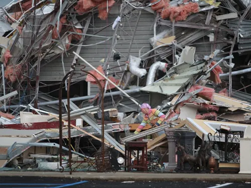 a woman stands by her house in tuscaloosa