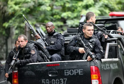 police officers ready their weapons in preparation for more gunfire