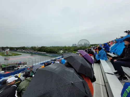 <i>Ver vóór de derde vrije training werden de eerste paraplu's al opgestoken op de tribune..</i>