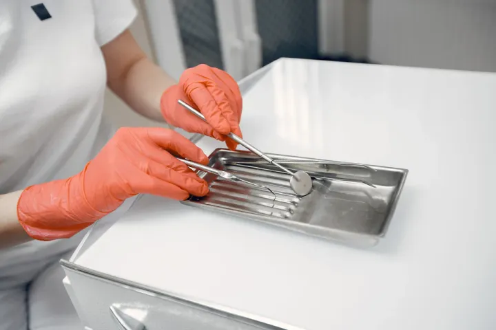 dentist takes instruments doctor protective gloves tool lies table jpg