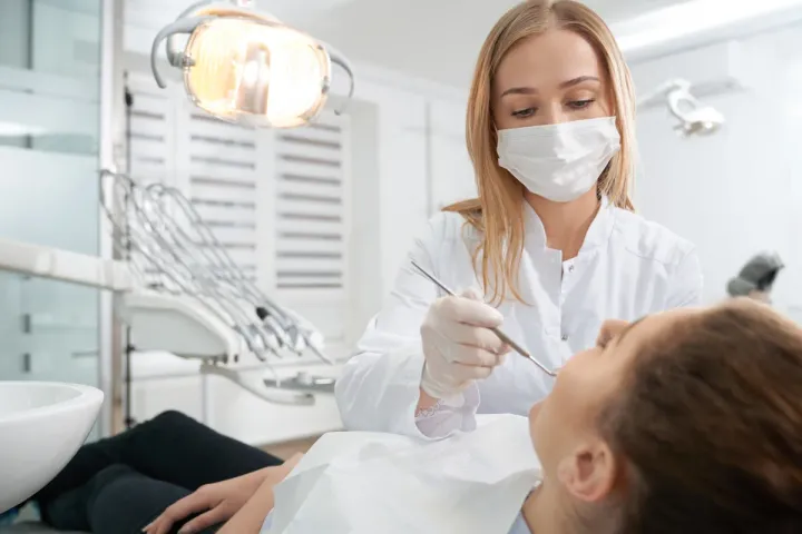 doctor medical mask treating teeth patient jpg
