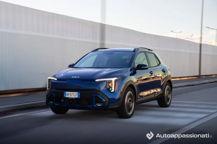 La Kia Stonic blu metallizzata ripresa dall'anteriore mentre percorre una strada pubblica