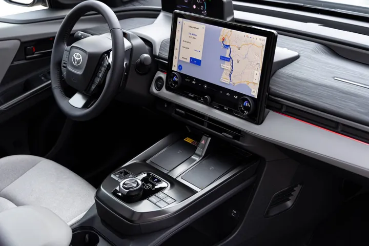 un dettaglio degli interni della Toyota C-HR+2026, con in primo piano la consolle centrale "flottante", il display da 14 pollici con comandi del clima fisici e i rivestimenti riciclati