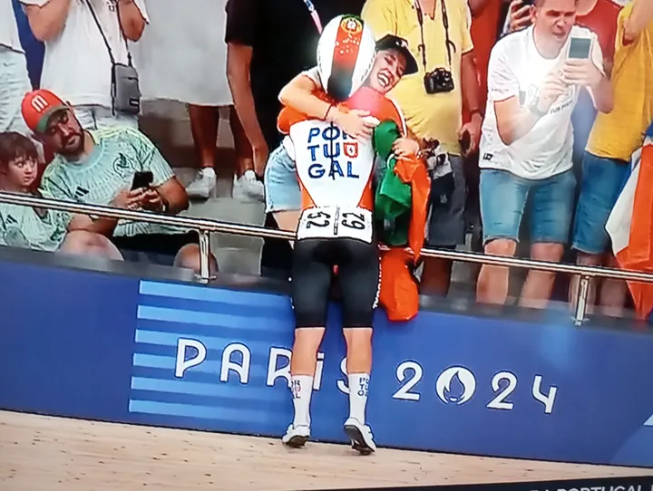 Iuri Leitão clings to his wife after winning Gold at the Madison alongside Rui Oliveira in Paris