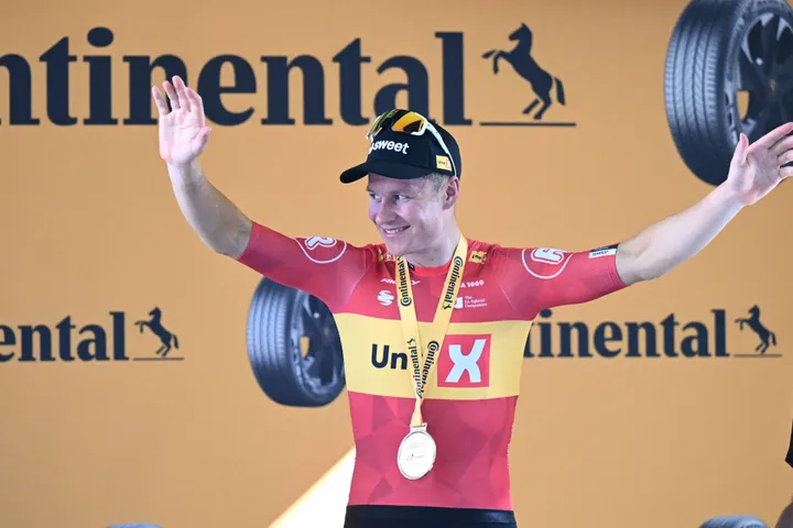 Jonas Abrahamsen stands on the Tour de France podium after his stage win