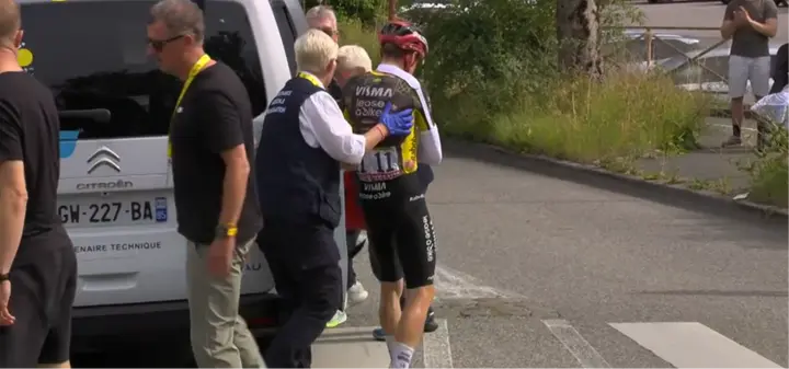 Jonas Vingegaard holds his arm as he heads to the ambulance in a heartbreaking farewell to the Tour de France.
