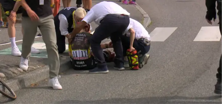Jonas Vingegaard being cared to on the ground after his fall at the Tour de France