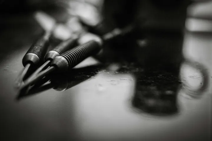 a-black-and-white-photo-of-pens-and-a-cell-phone-