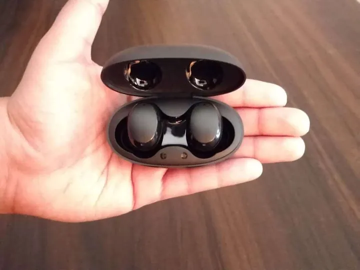 baseus encok w11 true wireless earbuds in palm