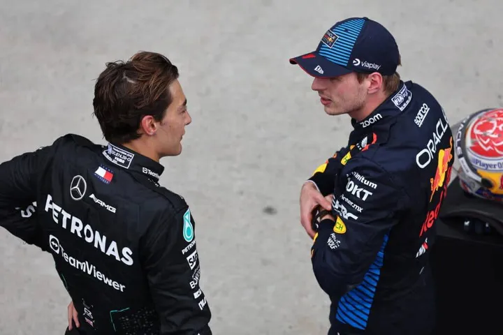 George Russell in conversation with Max Verstappen, with the two of them already having a flashpoint in their rivalry in 2025 after the Spanish Grand Prix