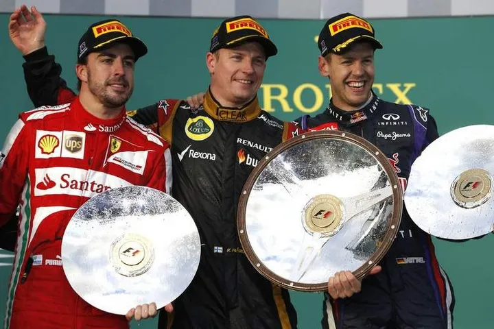 Albert Park, Melbourne, Australia Sunday 17th March 2013 Fernando Alonso, Ferrari, 2nd position, Kimi Raikkonen, Lotus F1, 1st position, and Sebastian Vettel, Red Bull Racing, 3rd position, with their trophies on the podium. World Copyright: Glenn Dunbar/LAT Photographic ref: Digital Image _89P5052
