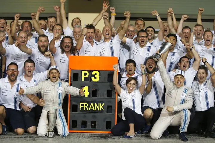 Yas Marina Circuit, Abu Dhabi, United Arab Emirates. Sunday 23 November 2014. Felipe Massa, Williams F1, Claire Williams, Deputy Team Principal, Williams F1, Valterri Bottas, Williams F1, and the Williams F1 team celebrate securing third in the Constructors Championship. Photo: Glenn Dunbar/Williams F1. ref: Digital Image _89P8670