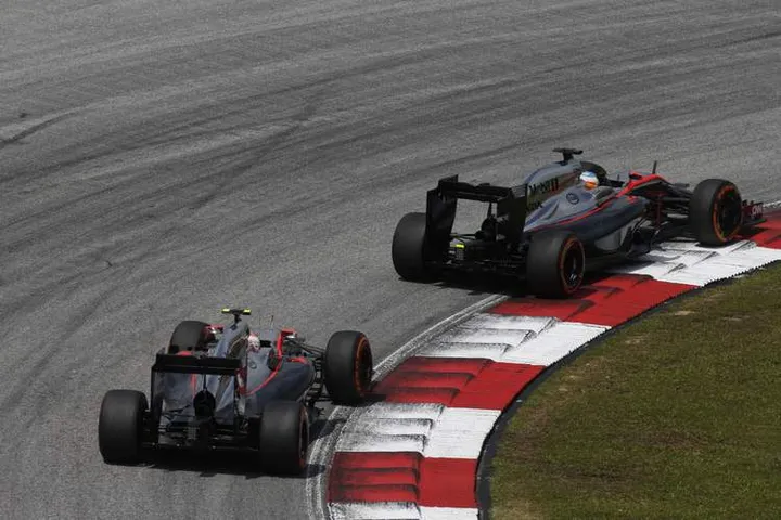 Fernando Alonso and Jenson Button on track.