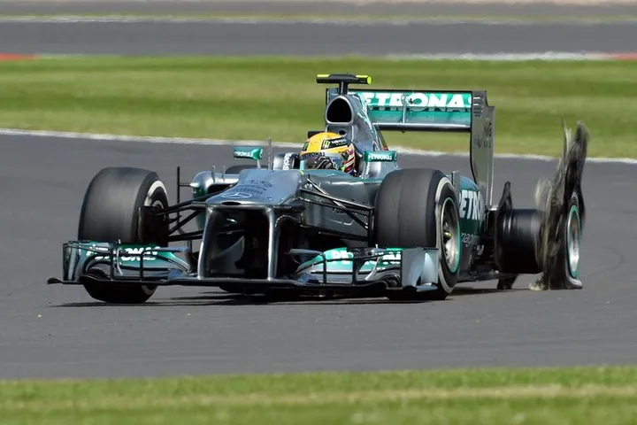 NORTHAMPTON, ENGLAND - JUNE 30:  Lewis Hamilton of Great Britain and Mercedes GP has a left rear tyre failure during the British Formula One Grand Prix at Silverstone Circuit on June 30, 2013 in Northampton, England.  (Photo by Lars Baron/Getty Images)