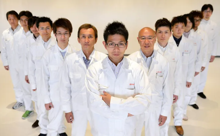 Ryo Mukumoto, engineer of Honda R&amp;D Co., center, poses for a photograph with members of the Honda Motor Co. S660 sports car development team in Haga Town, Tochigi Prefecture, Japan, on Tuesday, March 24, 2015. Photographer: Akio Kon/ Bloomberg
