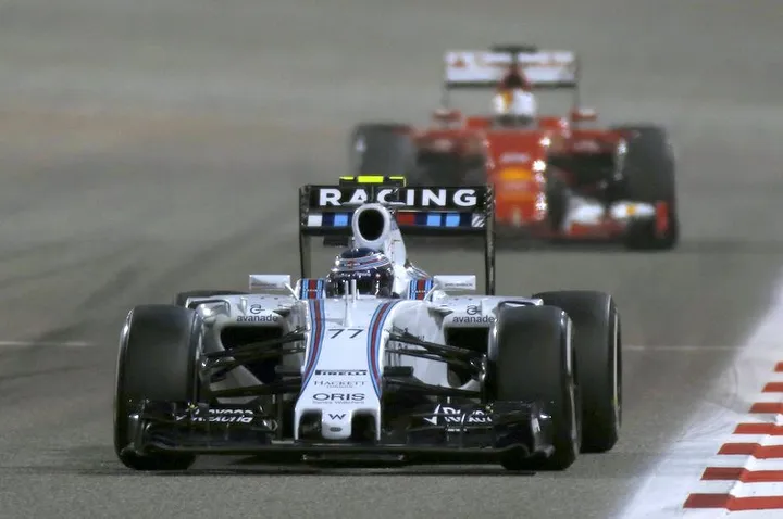 Bahrain International Circuit, Sakhir, Bahrain. Sunday 19 April 2015. Valtteri Bottas, Williams FW37 Mercedes, leads Sebastian Vettel, Ferrari SF-15T. Photo: Glenn Dunbar/Williams ref: Digital Image _89P0938