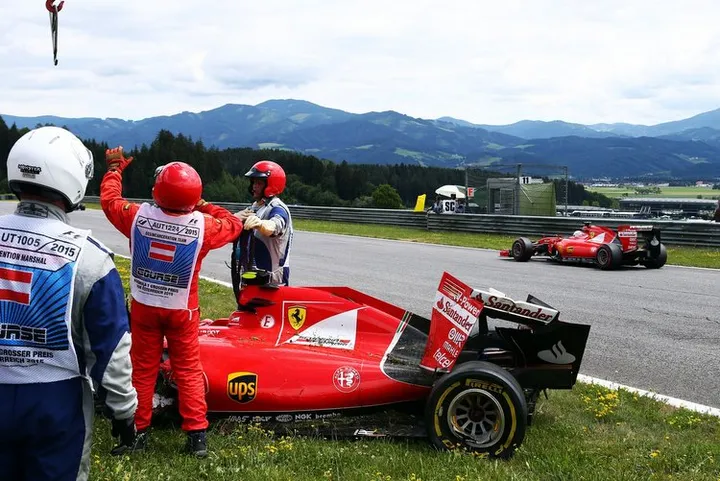 Formula One World Championship 2015, Round 8, Austrian Grand Prix, Spielberg, Austria, Sunday 21 June 2015 - Sebastian Vettel (GER) Ferrari SF15-T passes the damaged Ferrari SF15-T of team mate Kimi Raikkonen (FIN) Ferrari.