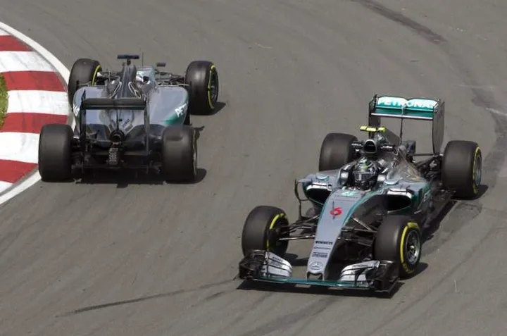Mercedes Formula One driver Nico Rosberg of Germany (R) passes teammate Lewis Hamilton of Britain as he spins out in the hairpin during the first practice session of the Canadian F1 Grand Prix at the Circuit Gilles Villeneuve in Montreal June 5, 2015. REUTERS/Christinne Muschi