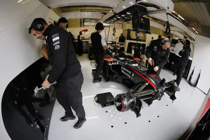 McLaren engineers working on Fernando Alonso's car.