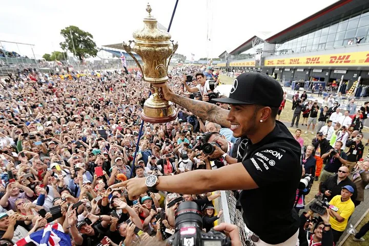 Lewis Hamilton shares a moment with the assembled masses at Silverstone after admitting he struggled