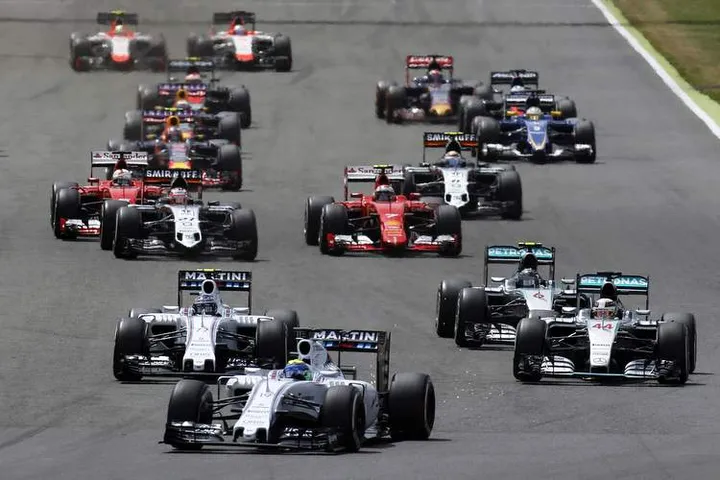 Silverstone, Northamptonshire, England. Sunday 5 July 2015. Felipe Massa, Williams FW37 Mercedes, and Valtteri Bottas, Williams FW37 Mercedes, take the lead from Lewis Hamilton, Mercedes F1 W06 Hybrid, and Nico Rosberg, Mercedes F1 W06 Hybrid, at the start. Photo: Alastair Staley/Williams ref: Digital Image W79P3136