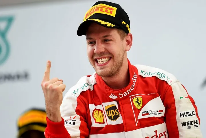 KUALA LUMPUR, MALAYSIA - MARCH 29: Sebastian Vettel of Germany and Ferrari celebrates on the podium after winning the Malaysia Formula One Grand Prix at Sepang Circuit on March 29, 2015 in Kuala Lumpur, Malaysia. (Photo by Lars Baron/Getty Images)