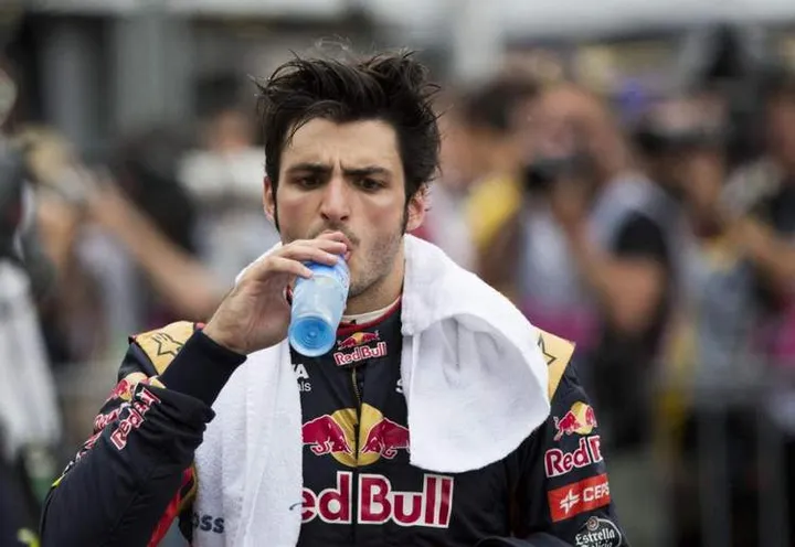 Toro Rosso driver Carlos Sainz Jr. of Spain walks through the pit lane after he clocked the eighth fastest time in the Qualifying session at the Monaco racetrack, in Monaco, Saturday, May 23, 2015. The Formula One Grand Prix of Monaco will be held on Sunday. (AP Photo/Gero Breloer)