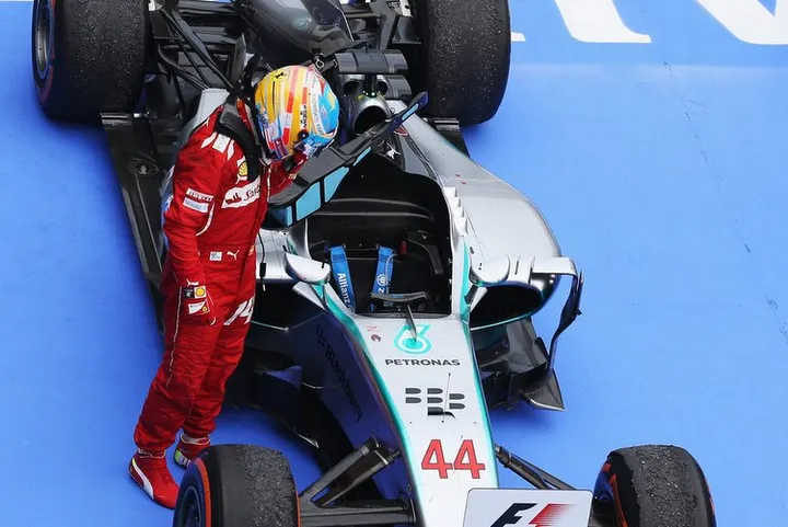 KUALA LUMPUR, MALAYSIA - MARCH 30: Fernando Alonso of Spain and Ferrari inspects the car of race winner Lewis Hamilton of Great Britain and Mercedes GP in parc ferme after the Malaysia Formula One Grand Prix at the Sepang Circuit on March 30, 2014 in Kuala Lumpur, Malaysia. (Photo by Mark Thompson/Getty Images)