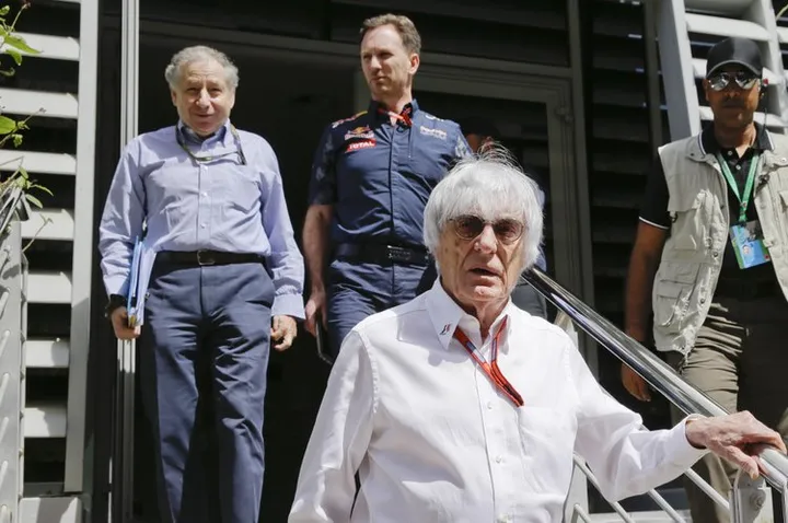 Bernie Ecclestone, chief executive of the Formula One Group, foreground, is followed by FIA president Jean Todt, left, and Red Bull team principal Christian Horner leave the press center after a meeting prior to the start of the Bahrain Formula One Grand Prix, at the Formula One Bahrain International Circuit, in Sakhir, Bahrain, Sunday, April 3, 2016. (AP Photo/Luca Bruno)
