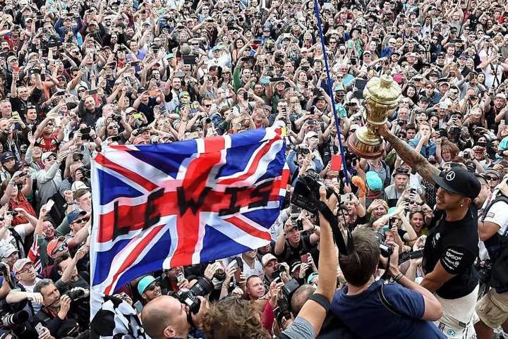 Lewis Hamilton celebrates with the fans after winning the British Grand Prix at Silverstone