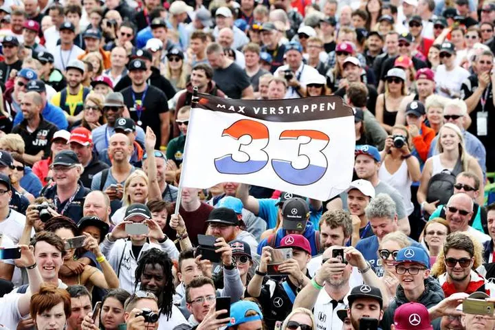 NORTHAMPTON, ENGLAND - JULY 09: Max Verstappen of Netherlands and Red Bull Racing fans hold a flag in the crowd during qualifying for the Formula One Grand Prix of Great Britain at Silverstone on July 9, 2016 in Northampton, England.  (Photo by Mark Thompson/Getty Images) // Getty Images / Red Bull Content Pool  // P-20160709-01184 // Usage for editorial use only // Please go to www.redbullcontentpool.com for further information. //