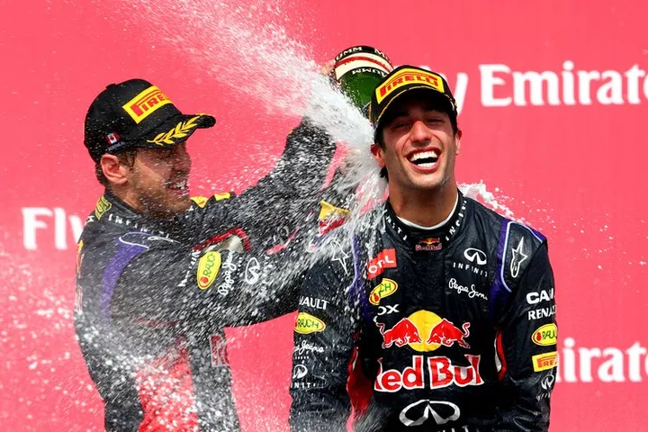 MONTREAL, QC - JUNE 08: Racewinner Daniel Ricciardo of Australia and Infiniti Red Bull Racing is sprayed with champagne by teammate Sebastian Vettel of Germany and Infiniti Red Bull Racing following his victory during the Canadian Formula One Grand Prix at Circuit Gilles Villeneuve on June 8, 2014 in Montreal, Canada. (Photo by Mark Thompson/Getty Images) *** Local Caption *** Daniel Ricciardo;Sebastian Vettel