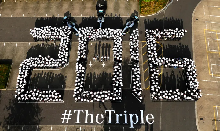 Mercedes celebrate the triple