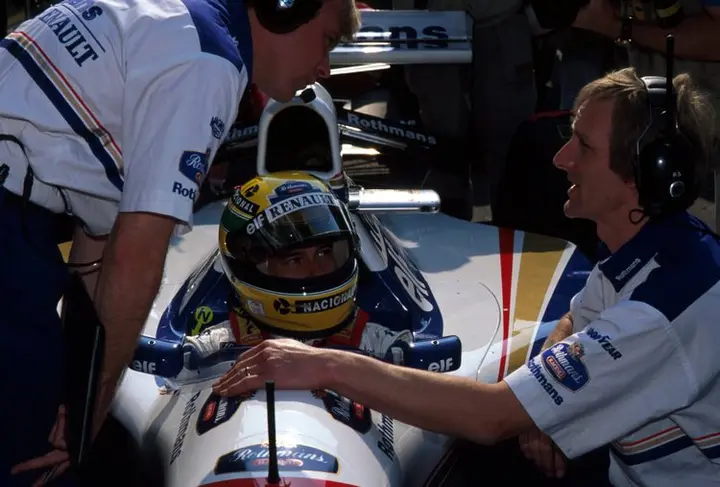 Ayrton Senna (BRA) Williams FW16 looks on as race engineer David Brown (left) talks to Williams team manager Dickie Stanford (right). Tragically Senna was killed on the sixth lap of the race.<br /> San Marino Grand Prix, Imola, Italy, 1 May 1994.