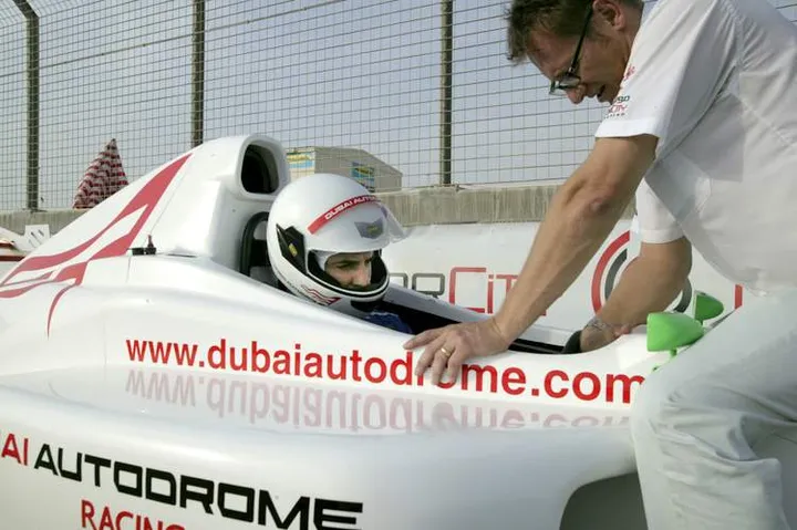 24JUL2006 MOTORSPORT Dubai Autodrome Chief Instructor Sean Stevens straps in Paul Velasco for a paced test of the new Formula Dubai single seater which will be part of the Autodrome's fleet of Race School cars. PHOTO: STUART AUSTEN
